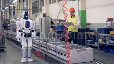 类似人类的机器人<strong>被打</strong>开，允许工厂工人开始钻孔